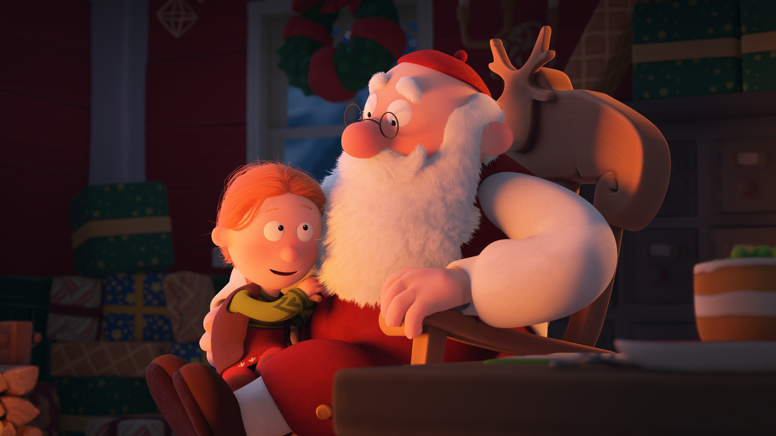 Kuvassa on Mauri Kunnaksen animaatiohahmoina Joulupukki ja hänen sylissään on pikkutyttö. Taustalla on tuolin selkämyksellä poronsarvet.