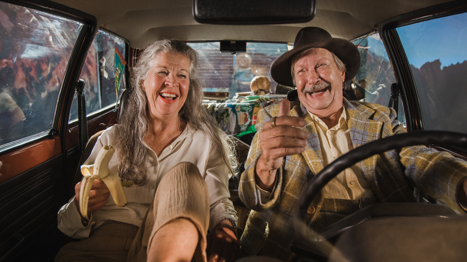 Kuvassa ovat Ingela Olsson ja Erkki Saarela autossa etupenkillä ja juttelevat iloisesti. 