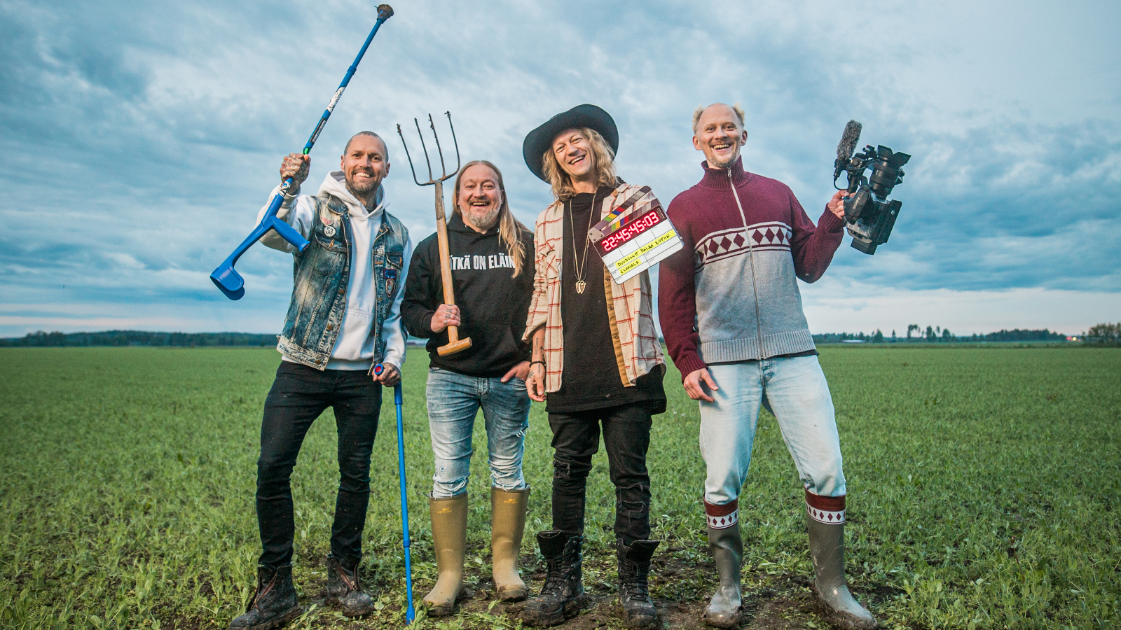 Kuvassa ovat Duudsonien neljä miestä ja heillä on erilaisia työvälineitä kädessään kuten talikko ja golfmaila. Heillä on eri värisiä farkkuja ja puseroita päällään. Taustalla on sini-valkoista taivasta ja alla vihreää heinäpeltoa.