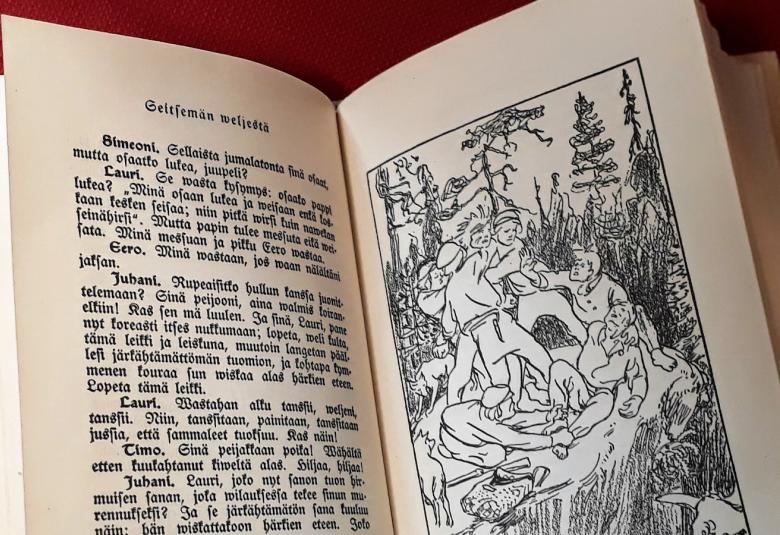 Kuvassa on aukeama Seitsemän veljestä -kirjasta.  Siinä on vasemmalla sivulla tekstiä vanhanaikaisella kirjaimilla ja oikealla musta-valkoinen piirroskuva Jukolan veljeksistä hiidenkivellä.