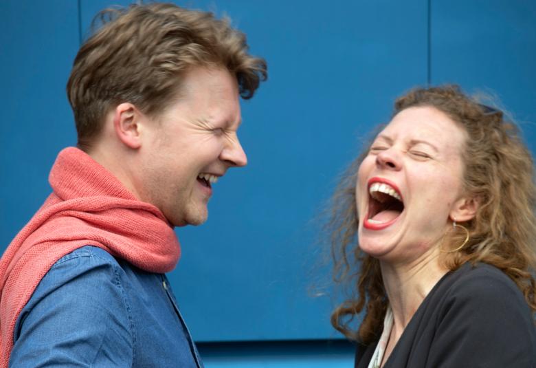 Kuvassa ovat Antti Tikkanen ja Minna Pensola iloisesti nauraen.  Kuva on puolivartalokuva.