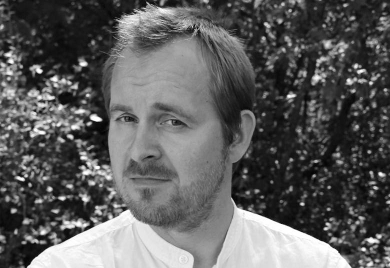 Kuvassa on Juha Mäntylä musta-valkoisessa kuvassa.  Kuva on kasvokuva.