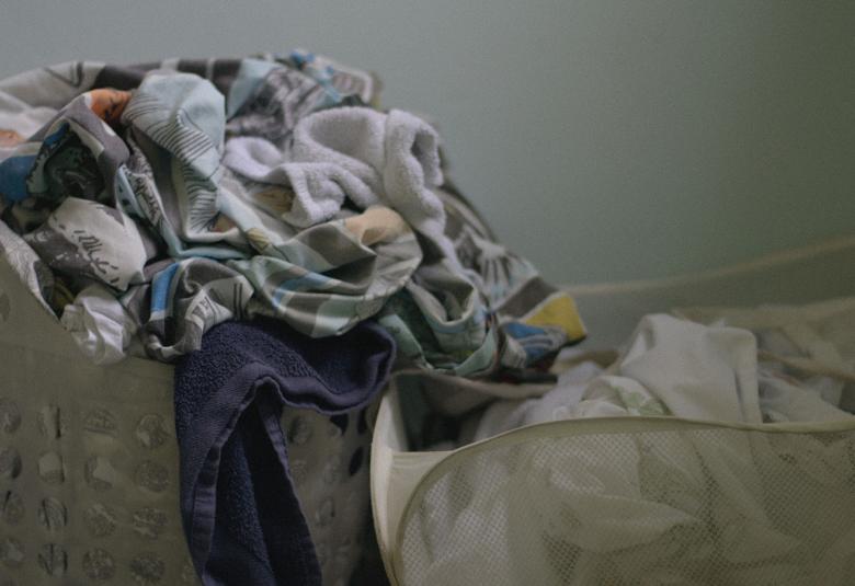 Kuvassa on kaksi harmaata kankaista pyykkikoria.