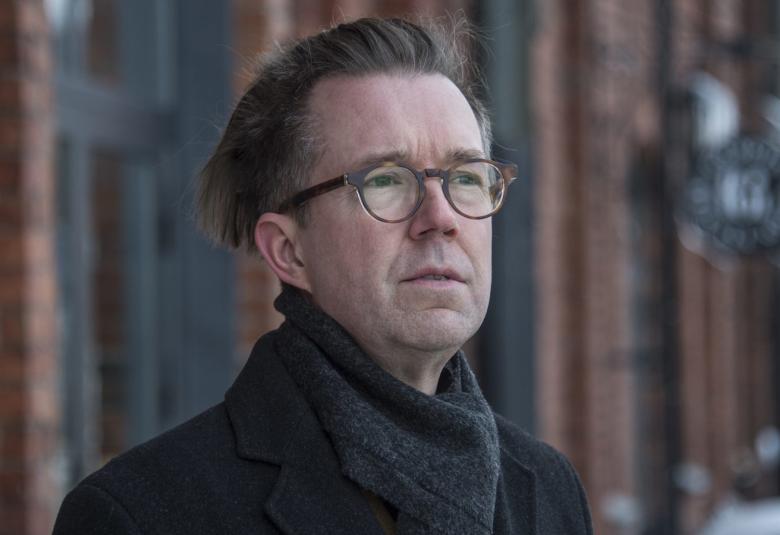 Kuvassa on Tuomas Parkkinen ja hänestä on puolivartalokuva ulkoilutakissa.