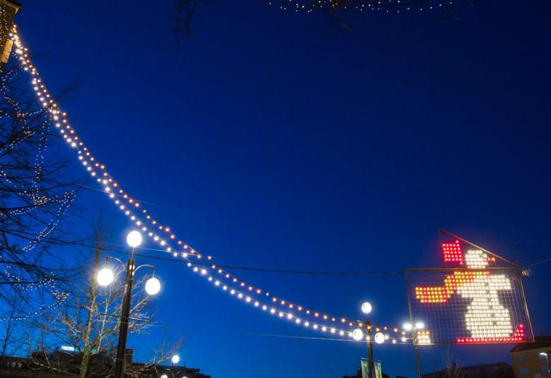 Kuvassa on valonauha ja valojoulupukki vasten pimeää iltataivasta.