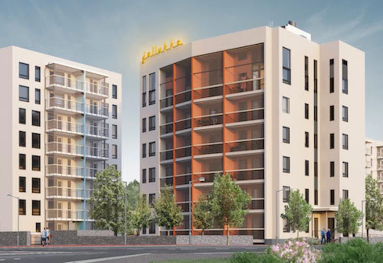 Kuvassa on kaksi kerrostaloa, joista toinen on sivuttain.  Väri on valkoinen ja toisessa on keskellä punaista seinää parvekkeiden alla.