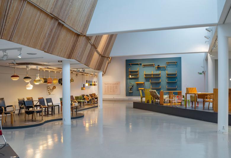 Kuvassa on Alvar Aalto-museon näyttelysali, jossa on seinillä Alvar Aallon töitä ja Aallon huonekaluja.