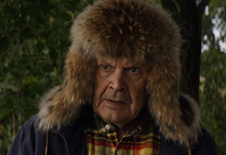 Kuvassa on Heikki Kinnunen karvahattu päässään ja pusakassa sekä ruutupaidassa.