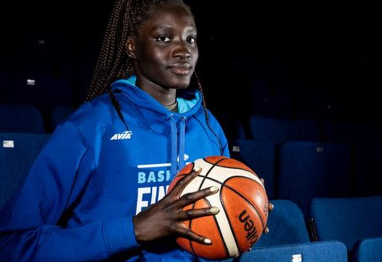 Kuvassa on Awak Kuier sinisessä verkkaripuserossa ja kädessään oranssi koripallo.