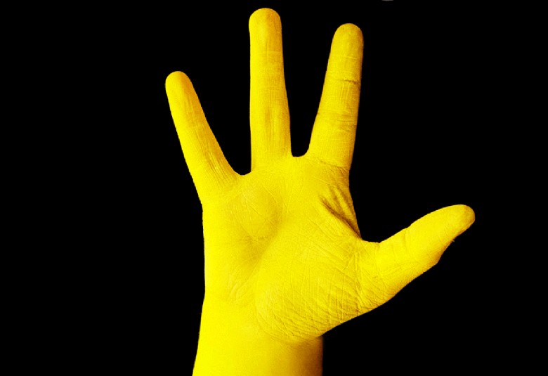 Kuvassa on mustalla pohjalla keltainen käsi.  Kuva on osa julisteesta.