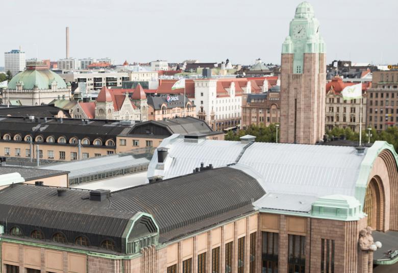 Kuvassa on Helsingin päärautatieasema kuvattuna ylhäältä päin.  Siinä näkyy taaempana kellotorni ja etualalla rakennusta ja etuovia. Rakennus on ruskea.