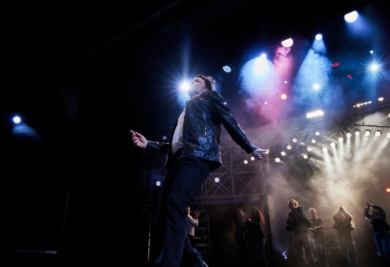 Kuvassa on Leena Lehtolainen kasvokuvassa.  Hänellä on pitkähköt punaruskeat, kiharat hiukset ja musta t-paita.