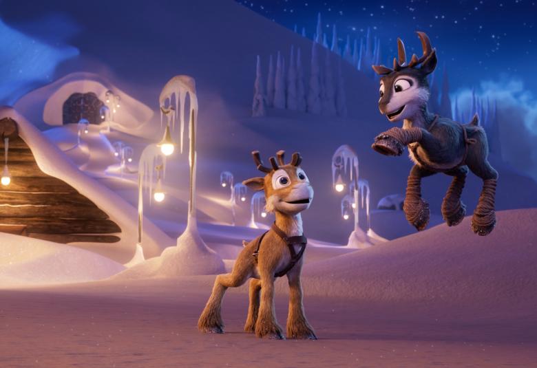 Kuvassa on animaatiokuva, jossa on iltataivasta ja vasemmalla lumen peittämä hirsirakennus, jonka mpärillä on valoja. Keskellä edessä on poro Stella ja oikealla vähän ylempänä lumikummun päällä poro Niko, joka ojentaa vasenta etukaviota. 