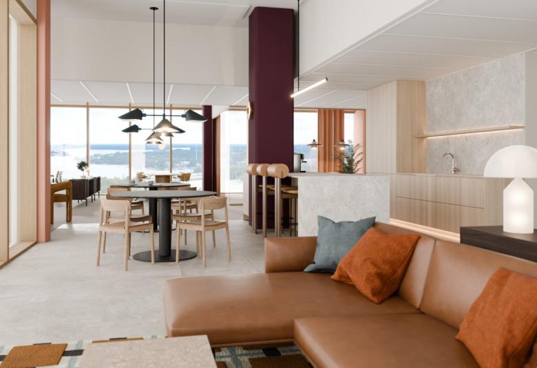 Kuvassa on Keilaniemen Föörin toimistotilaa ja siinä on beigen sävyt lähtien lattian väristä- Vasemmalla on isot ikkunat ja oikealla on ruskea nahkainen kulmasohva. Taaempana näkyy puinen pöytäkalusto ja vasemmasta kulmasta näkyy tummaa kokouskalustoa. Oikealla takana on valkoista baarikeittiötä.