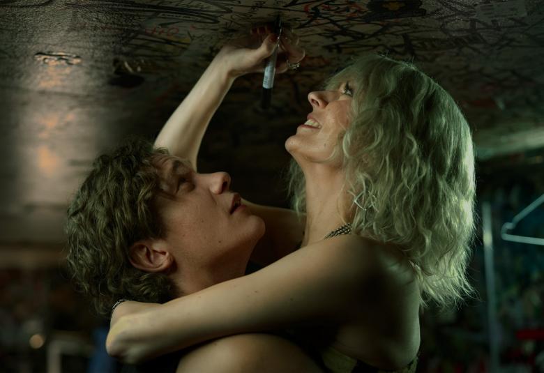 Kuvassa ovat Pyry Kähkönen vasemmalla ja Rita Behm oikealla sylikkäin sivuttain seksuaalisessa kanssakäymisessä alasti. Kuvan sävy on tumma.