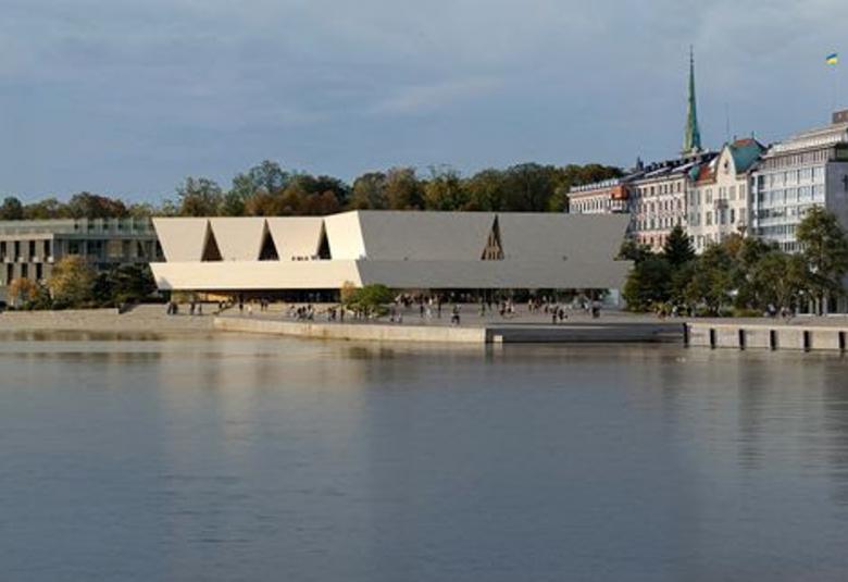 Kuvassa on havainnekuva uudesta arkkitehtuuri- ja designmuseosta,joka on valkoinen ja siinä on eräänlaisella jalustalla neljä palkkimaista, ylöspäin nousevaa rakennetta. Edessä on merivettä ja vasemmalla ruskea rakennus ja oikealla vaaleita vanhoja rakennuksia. Taustalla on sinistä taivasta.