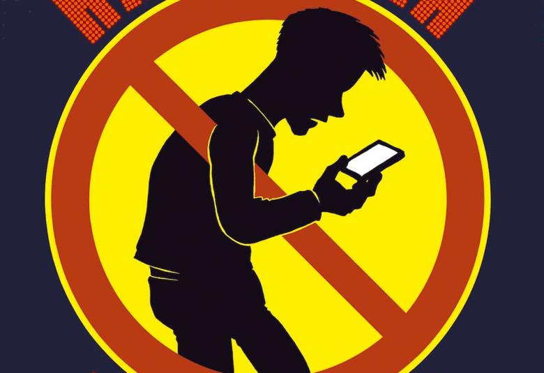 Kuvassa on mustalla pohjalla ympyrn mallinen punareunainen, keltainen kieltomerkki ja sen keskellä on miehen hahmo, joka tuijottaa kännykkää.