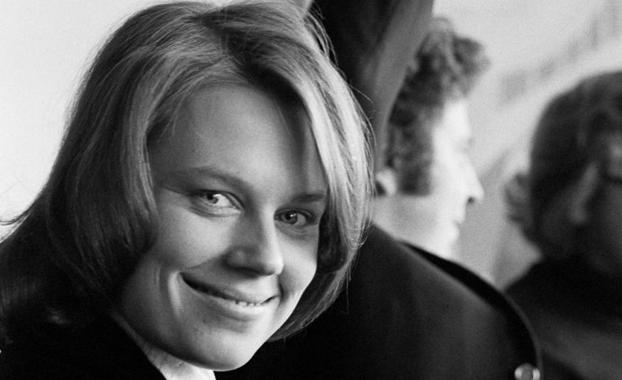 Kuvassa on Arja Saijonmaa nuorena kasvokuvass. Taustalla näkyy Mikis Theodorakis selin ja osaa kasvoista. Kuva on musta-valkoinen.
