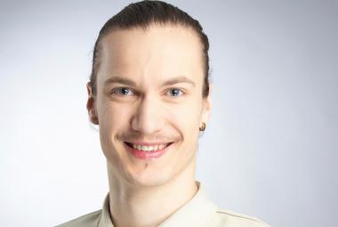  Kuvassa on Samuli Emery kasvokuvassa. Hänellä on kellertävä paita päällään. Tausta on vaalea.